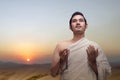 Asian Muslim man in ihram clothes praying with prayer beads on his hands Royalty Free Stock Photo