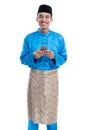Asian muslim man with mobile phone wearing koko melayu