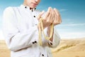 Asian Muslim man praying with prayer beads on his hands Royalty Free Stock Photo