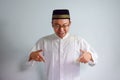Asian Muslim man wearing glasses and white cloth smiling pose for ramadhan