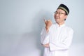 Asian Muslim man wearing glasses and white cloth smiling pose for ramadhan