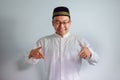 Asian Muslim man wearing glasses and white cloth smiling pose for ramadhan