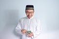 Asian Muslim man wearing glasses and white cloth smiling pose for ramadhan