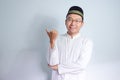 Asian Muslim man wearing glasses and white cloth smiling pose for ramadhan