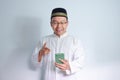 Asian Muslim man wearing glasses and white cloth smiling pose for ramadhan