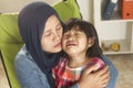 Asian muslim mother hijab calming her sad and crying daughter, single mom and baby girl together Royalty Free Stock Photo