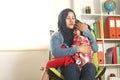 Asian muslim mother hijab calming her sad and crying daughter, single mom and baby girl together Royalty Free Stock Photo