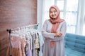 asian muslim small boutique shop smiling to camera