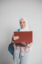 asian muslim student holding laptop in front of white Royalty Free Stock Photo