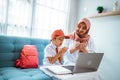 asian muslim student praying before starting her online class from home Royalty Free Stock Photo