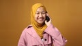 Asian Muslim Teenage Girl Smiling When Talking on Phone Royalty Free Stock Photo