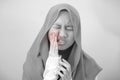 Asian muslim teenage girl suffering from toothache pain Royalty Free Stock Photo