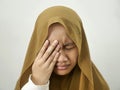 Asian muslim teenage girl wearing hijab crying and close her eye, depression or sore eyes Royalty Free Stock Photo