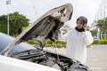 asian muslim woman broken car have a problem on road. Female trying fix their car and calling to motor car mechanic and calls Royalty Free Stock Photo