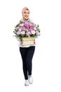 Asian Muslim woman in a headscarf holding a flower bucket