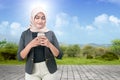 Asian Muslim woman in a headscarf holding a mobile phone Royalty Free Stock Photo