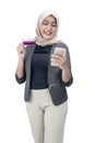 Asian Muslim woman in a headscarf holding a mobile phone and credit card Royalty Free Stock Photo