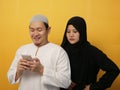 Asian muslim woman looked jelaous of her husband man doing chat with other girl on phone, bad couple relationship