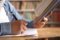 Asian muslim woman studying in library, exam preparation concept. Female college student doing research and making notes in her Royalty Free Stock Photo