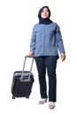 Asian muslim woman traveler walking forward drag his suitcase luggage, low angle full length portrait Royalty Free Stock Photo