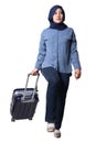 Asian muslim woman traveler walking forward drag his suitcase luggage, low angle full length portrait Royalty Free Stock Photo