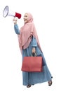 Asian Muslim woman in veil holding megaphone and shopping bags Royalty Free Stock Photo