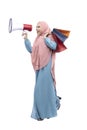 Asian Muslim woman in veil holding megaphone and shopping bags Royalty Free Stock Photo
