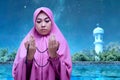 Asian Muslim woman in veil praying with prayer beads on her hands Royalty Free Stock Photo