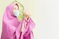 Asian Muslim woman in a veil and wearing flu mask praying with prayer beads Royalty Free Stock Photo