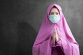 Asian Muslim woman in a veil and wearing flu mask praying Royalty Free Stock Photo