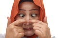 Asian muslim woman wearing hijab pinched her acne on nose with funny face, squeezing pimple