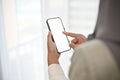 Asian Muslim woman wearing hijab using her mobile phone. Phone white screen mockup Royalty Free Stock Photo