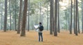 Asian naturalist looking at the map for direction while exploring wildlife in the pine forest for surveying and discovering the Royalty Free Stock Photo