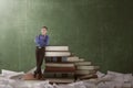 Asian nerd man leaning on the big books Royalty Free Stock Photo