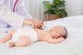 Asian newborn baby get sick sleep during examine by pediatrician doctor hand hold stethoscope, Little child in medicine hospital. Royalty Free Stock Photo