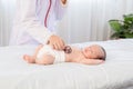 Asian newborn baby get sick sleep during examine by pediatrician doctor hand hold stethoscope, Little child in medicine hospital. Royalty Free Stock Photo