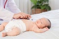 Asian newborn baby get sick sleep during examine by pediatrician doctor hand hold stethoscope, Little child in medicine hospital. Royalty Free Stock Photo