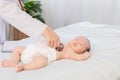 Asian newborn baby get sick sleep during examine by pediatrician doctor hand hold stethoscope, Little child in medicine hospital. Royalty Free Stock Photo