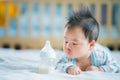 Asian Newborn baby smile with milk power bottle Royalty Free Stock Photo