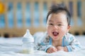 Asian Newborn baby smile with milk power bottle Royalty Free Stock Photo