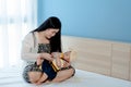 Asian newborn cute baby girl, lying on mother`s lap, mother`s hand feeding from a baby bottle to drink, little baby lying down