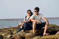 Asian newly married couple sitting on the coral of a sea beach having a romantic time Royalty Free Stock Photo