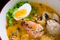 Asian noodle with seafood and egg in the tomyum soup