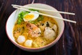 Asian noodle with seafood and egg in the tomyum soup