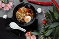 Asian noodle soup, ramen with chicken, tofu, vegetables and egg in black bowl. Slate background Royalty Free Stock Photo