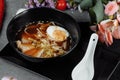 Asian noodle soup, ramen with chicken, tofu, vegetables and egg in black bowl. Slate background Royalty Free Stock Photo