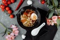 Asian noodle soup, ramen with chicken, tofu, vegetables and egg in black bowl. Slate background Royalty Free Stock Photo