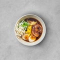 Asian noodle soup, ramen with meat, tofu, vegetables, enoki mushrooms and egg in black bowl Royalty Free Stock Photo