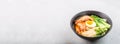 Asian noodle soup, ramen with prawn shrimp, vegetables and egg in black bowl on gray concrete background. Flat lay, Top view, mock Royalty Free Stock Photo