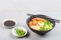 Asian noodle soup, ramen with prawn shrimp, vegetables and egg in black bowl on gray concrete background. Flat lay, Top view, mock Royalty Free Stock Photo